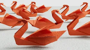 a group of orange origami swans sitting on top of a table jigsaw puzzle