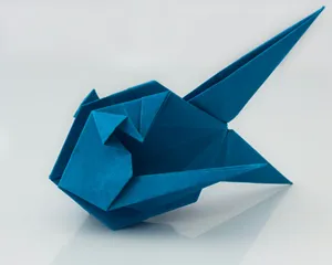 a blue origami bird sitting on top of a table jigsaw puzzle