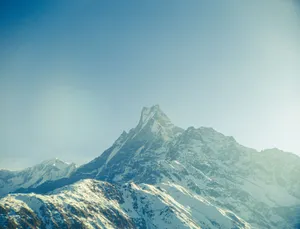 Snow-capped Himalayan peak under a clear blue sky, ideal for travel and adventure themes. jigsaw puzzle