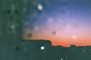 Abstract silhouette of cityscape against a vibrant sunset sky with bokeh lights. jigsaw puzzle