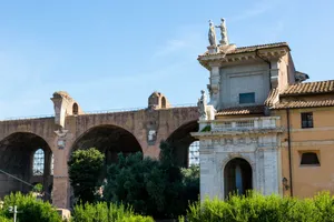 Capture of ancient Roman architecture featuring arches and statues under a clear summer sky. jigsaw puzzle