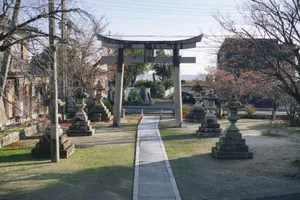 Serene Japanese garden in Shiga with a traditional torii gate and stone lanterns under sunlight. jigsaw puzzle
