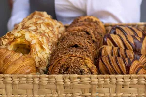 Close-up view of a basket filled with assorted French pastries, perfect for bakery lovers. jigsaw puzzle
