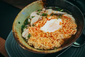 A savory bowl of ramen with poached egg, chicken, and green onions, perfect for a comforting meal. jigsaw puzzle