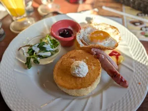 A scrumptious breakfast featuring pancakes, fried egg, sausage, and salad, perfect for a morning meal. jigsaw puzzle