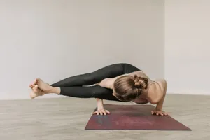 Adult woman practicing an advanced yoga pose on a mat indoors, showcasing flexibility and balance. jigsaw puzzle