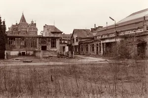 Sepia-toned image of an abandoned historical palace building showcasing a decayed facade and overgrown environment. jigsaw puzzle