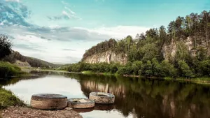three wooden barrels sitting on the shore of a river jigsaw puzzle