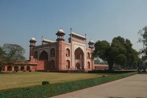 A red and white building sitting on top of a lush green field jigsaw puzzle