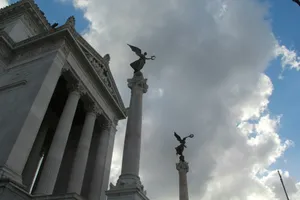 Two winged statues atop columns against cloudy sky jigsaw puzzle