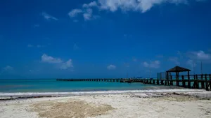 Wooden pier extending into turquoise ocean under blue sky jigsaw puzzle