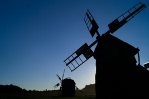 Silhouettes of windmills against a clear blue sky. jigsaw puzzle