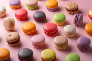 a bunch of different colored macaroons on a pink surface jigsaw puzzle