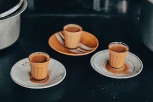 three orange cups and saucers on a black table jigsaw puzzle