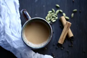 a cup of coffee sitting on top of a table jigsaw puzzle