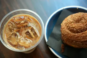 Iced coffee and a pastry on a wooden table jigsaw puzzle