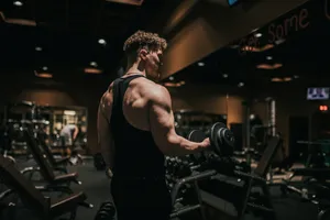 a man holding a dumbbell in a gym jigsaw puzzle