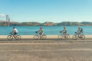 man in red shirt riding bicycle on road during daytime jigsaw puzzle
