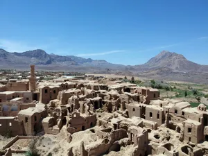 a village in the middle of a desert with mountains in the background jigsaw puzzle