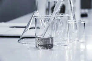 three clear beakers placed on tabletop jigsaw puzzle