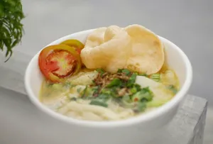 a bowl of soup with a tomato and chips jigsaw puzzle