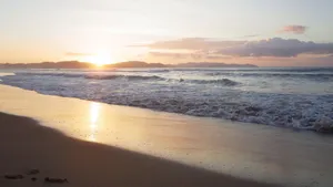 Capture of a breathtaking sunrise on San Vicente Beach, featuring golden sand and gentle waves. jigsaw puzzle