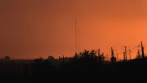 City silhouette with an orange sky backdrop at sunset, capturing urban tranquility. jigsaw puzzle