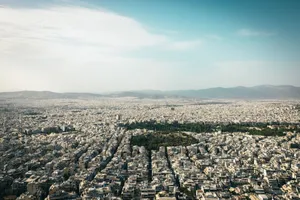 Aerial view of Athens cityscape showcasing urban density with mountains in the background. jigsaw puzzle