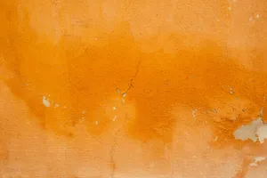 an orange wall with peeling paint on it jigsaw puzzle