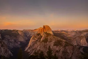 Majestic mountain peak bathed in warm sunset light. jigsaw puzzle