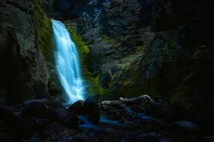 a small waterfall in the middle of a rocky area jigsaw puzzle