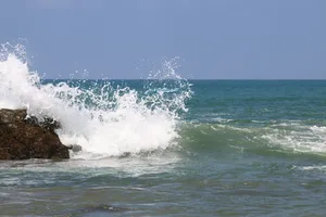 a person riding a surfboard on a wave in the ocean jigsaw puzzle