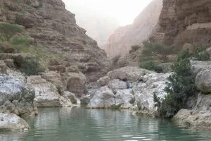 a body of water surrounded by rocky mountains jigsaw puzzle