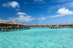 brown wooden house on blue water under blue sky during daytime jigsaw puzzle