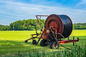 brown and black tractor on green grass field during daytime jigsaw puzzle