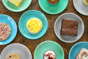 a table topped with lots of different types of cakes jigsaw puzzle