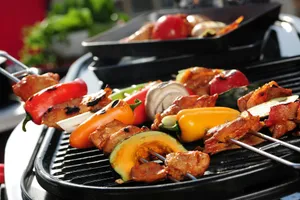 a close up of a grill with meat and vegetables on it jigsaw puzzle