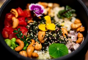 A colorful bowl of rice with cashews and vegetables. jigsaw puzzle