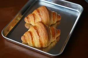 three croissants sitting on a metal pan jigsaw puzzle