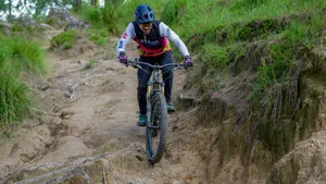 Woman riding a mountain bike downhill on a dirt trail. jigsaw puzzle