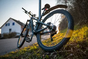 Mountain bike leaning on a pole in golden hour light. jigsaw puzzle