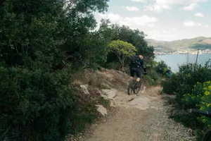 Cyclist on a rocky path overlooking the sea. jigsaw puzzle