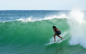 man in black shorts surfing on sea waves during daytime jigsaw puzzle