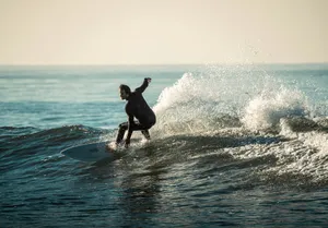 a person riding a surfboard on a wave in the ocean jigsaw puzzle