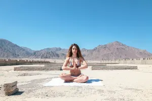 woman wearing two-piece meditating under blue sky during daytime jigsaw puzzle