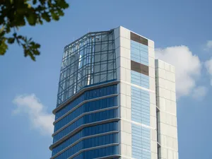 Modern glass skyscraper against a blue sky jigsaw puzzle