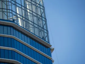 Modern glass building against a clear blue sky jigsaw puzzle