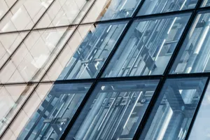 a tall building with lots of windows reflecting the sky jigsaw puzzle
