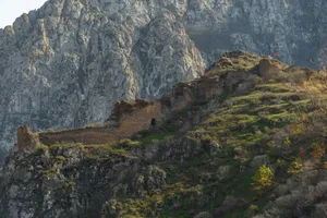 a rocky mountain with a small tower on top of it jigsaw puzzle