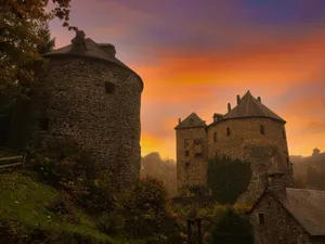 brown concrete castle on green grass field during sunset jigsaw puzzle